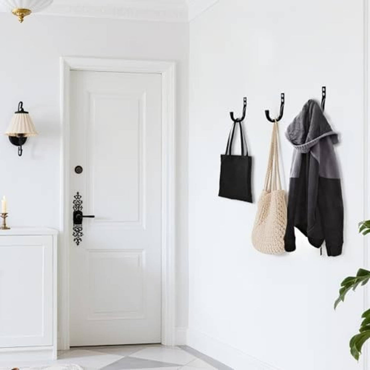Black wall hooks with two hang points for coats, towels, and tote bags