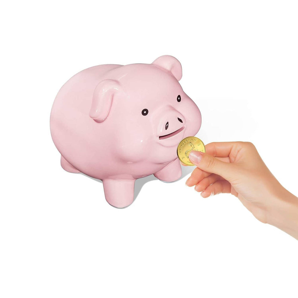 Pink ceramic piggy bank with a hand holding a coin near the opening