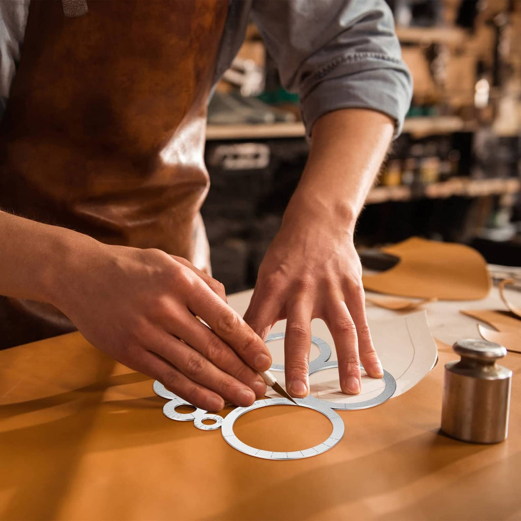 Hands using a round corner template on leather to mark and cut clean rounded corners