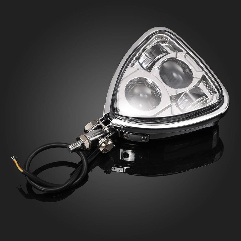 Triangular front motorcycle headlight with chrome housing, lens reflectors and wiring leads