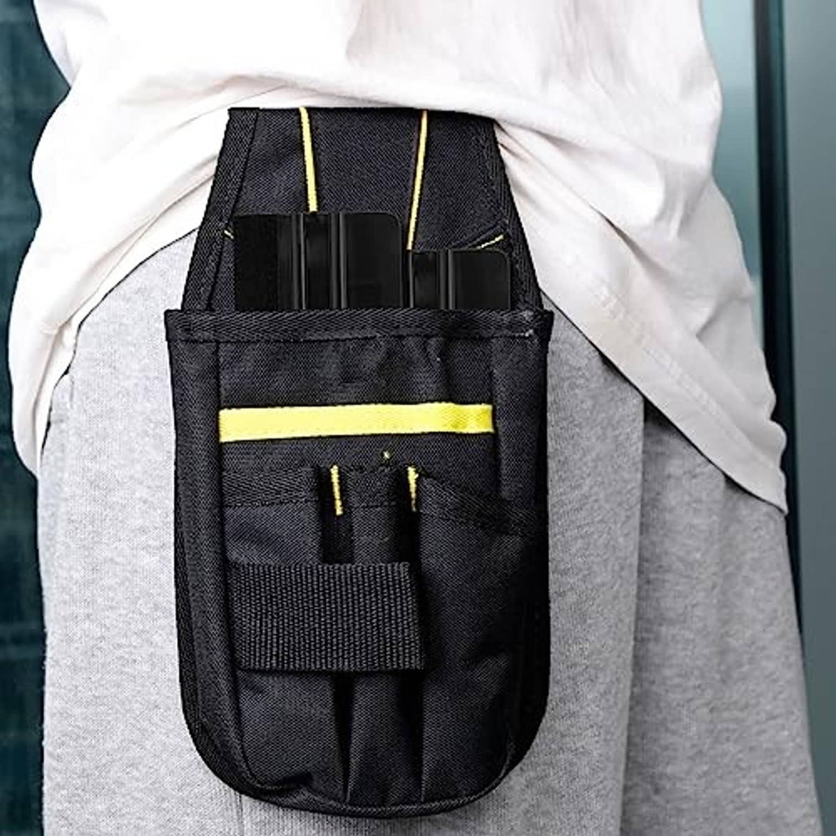 Black squeegee tool pouch holding ribbed felt scraper tools with yellow trim.