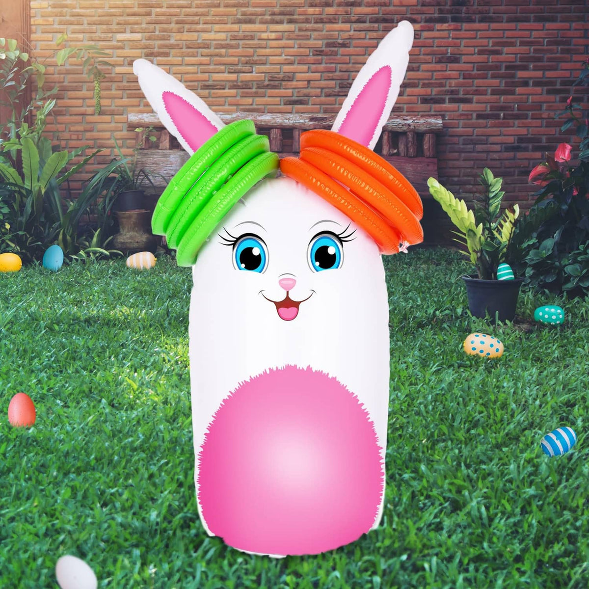 Inflatable bunny yard game with green and orange rings on top, pink belly front view