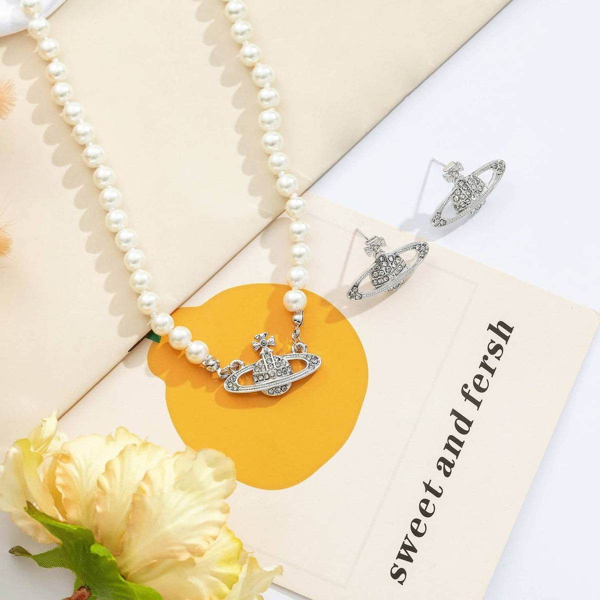 White pearl choker necklace with silver Saturn pendant and matching stud earrings