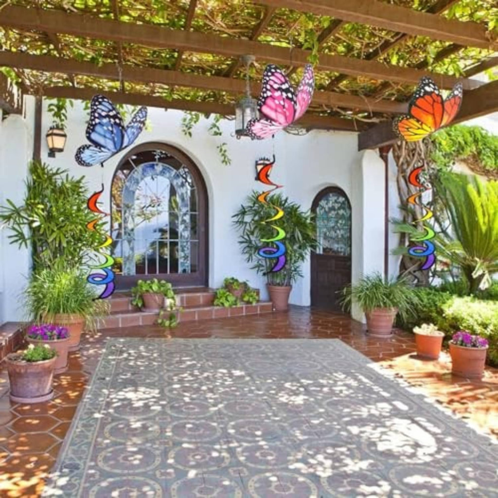 Butterfly wind spinners with rainbow curlie spring tails hanging along a covered patio