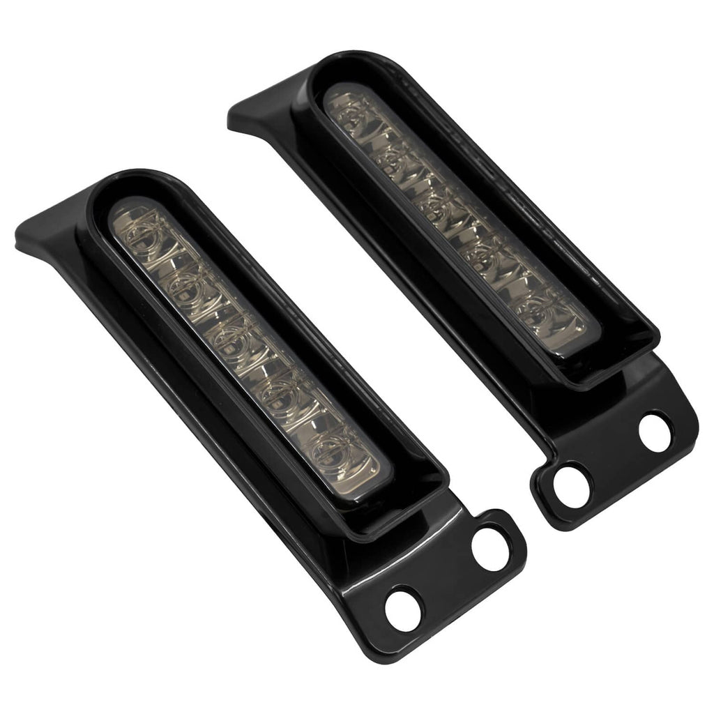 Angled view of black LED saddlebag filler lights with clear rectangular lenses (pair).