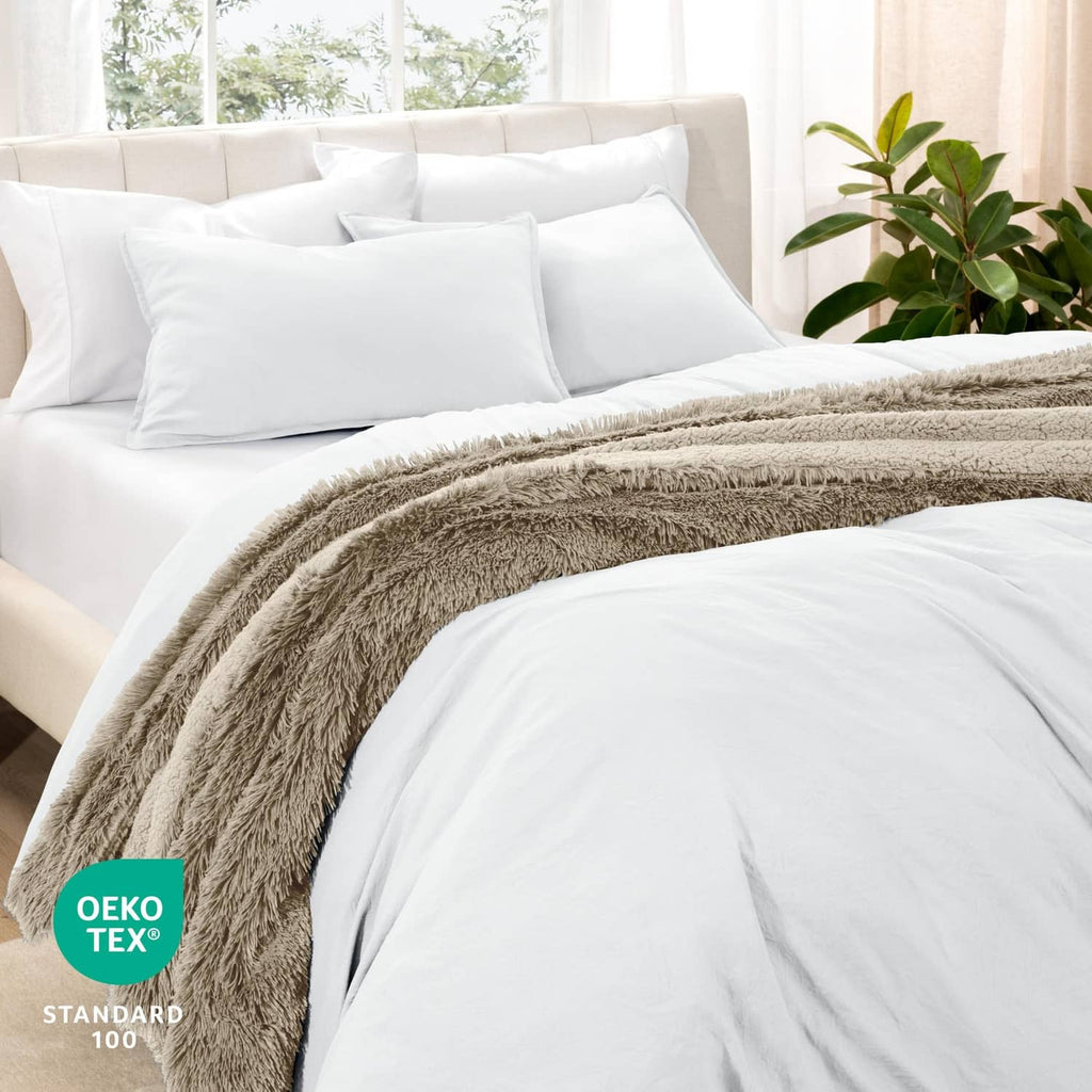 White queen duvet cover set with pillow shams, layered with gray throw blanket