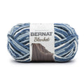 Bernat Blanket yarn skein in blue-and-white stripes, with Bernat label on wrapper
