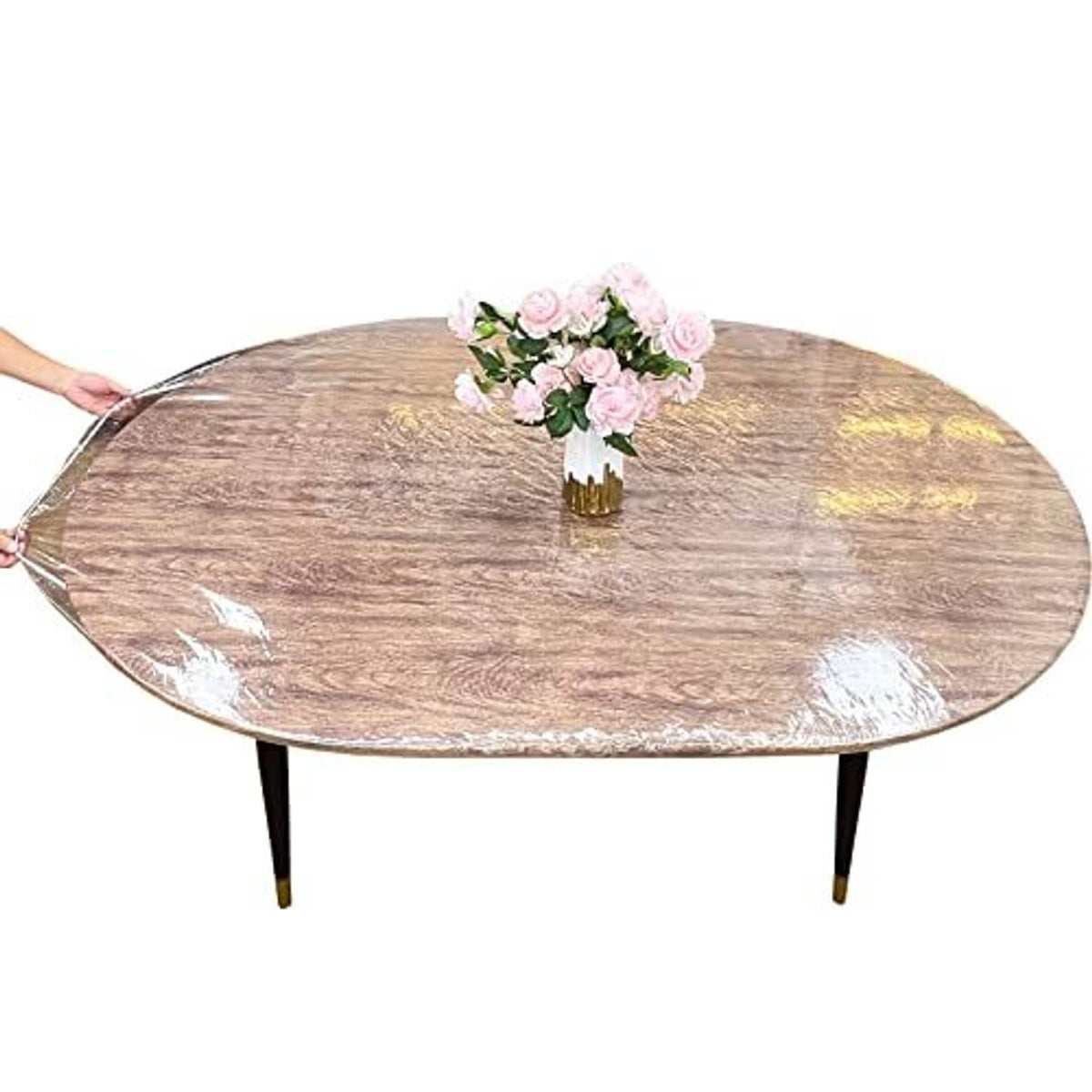 Clear plastic oval table cover (48 x 68 in) draped over table with flower centerpiece