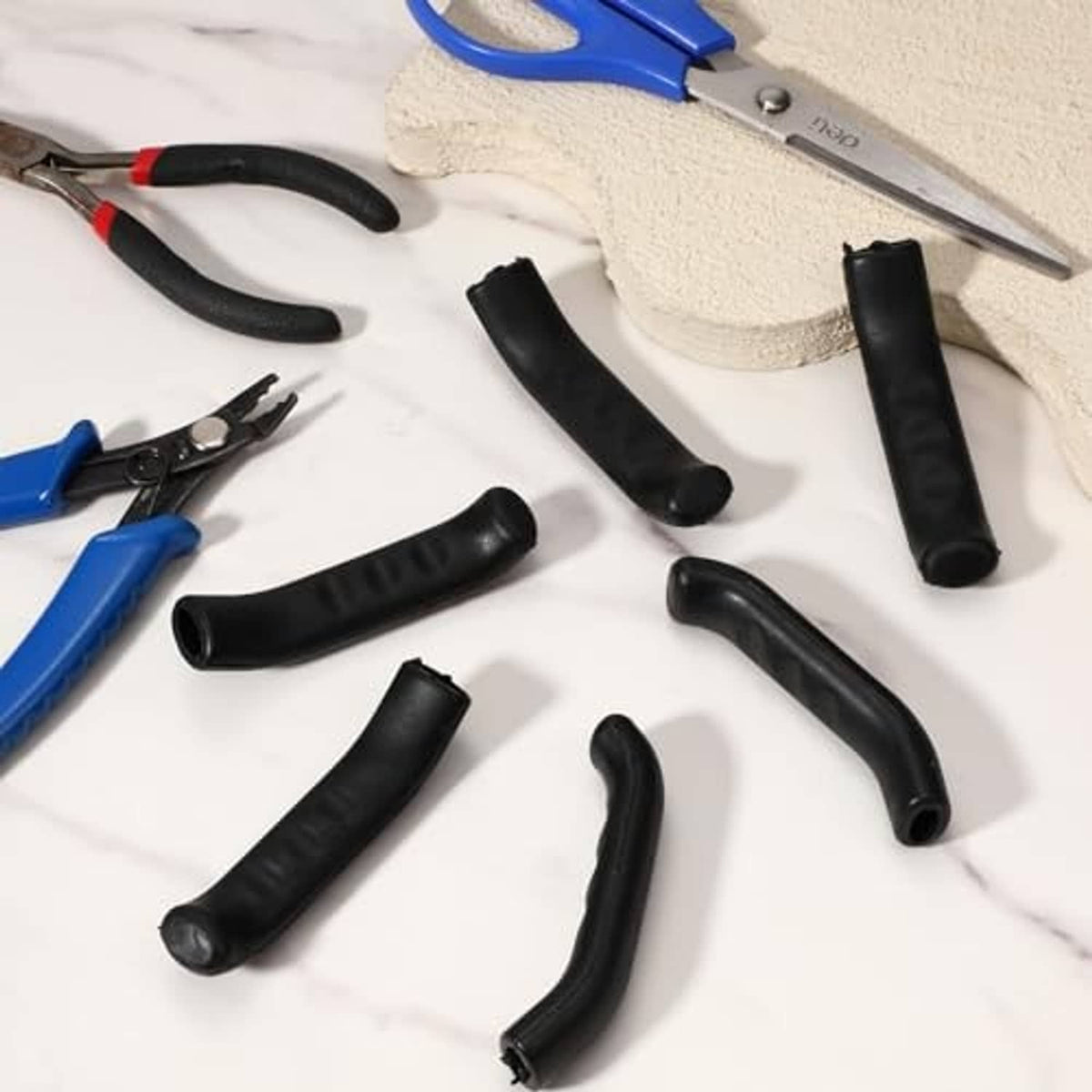 Black bicycle brake lever sleeves and installation tools laid out for fitting
