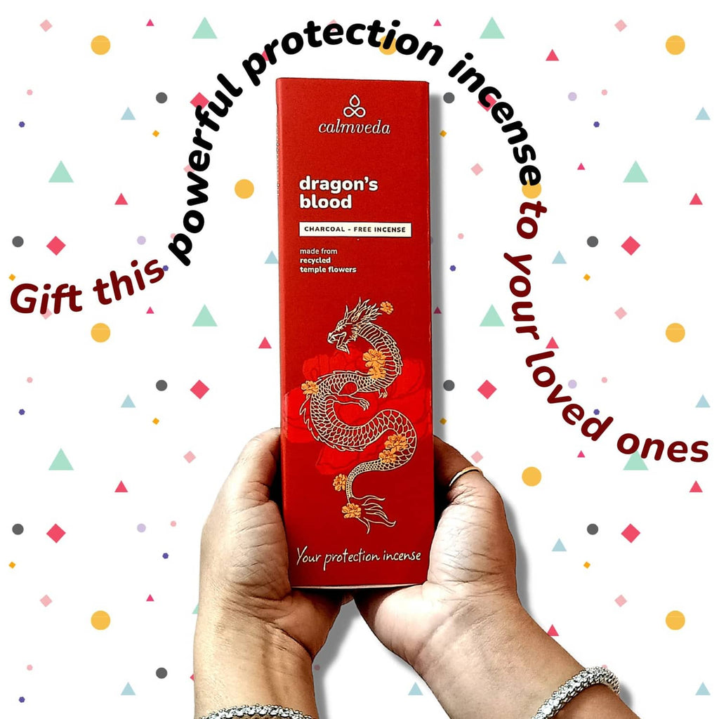 Red dragon’s blood incense box held in hands with dragon illustration and gift design