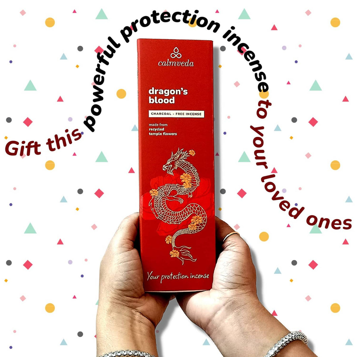 Red dragon’s blood incense box held in hands with dragon illustration and gift design