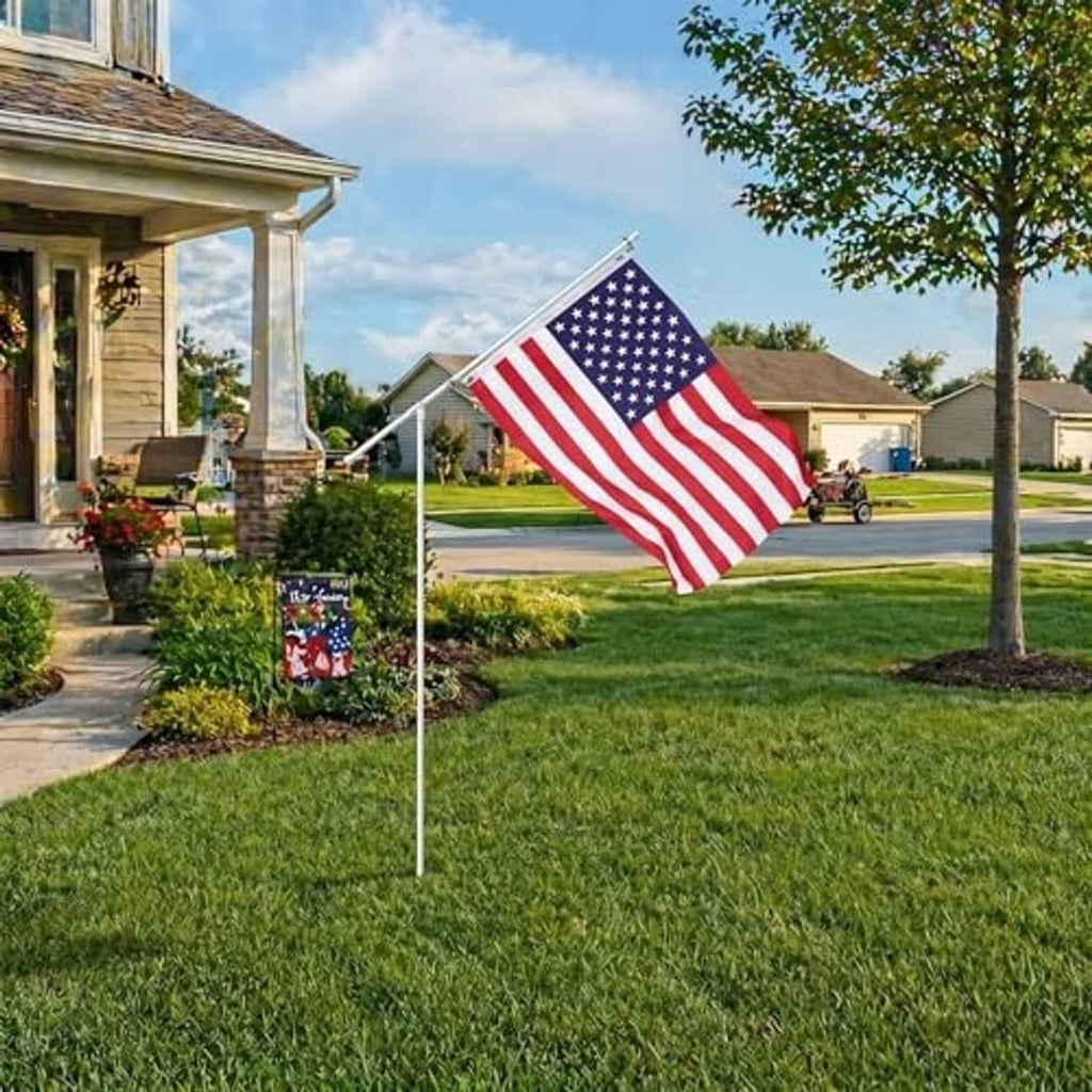 American flag on a white telescoping pole with ground stake, positioned outdoors