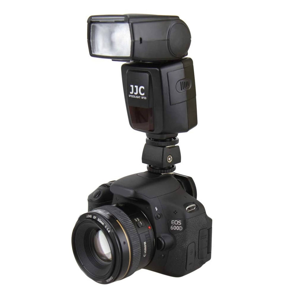 Camera with JJC hot shoe adapter connecting a flash unit