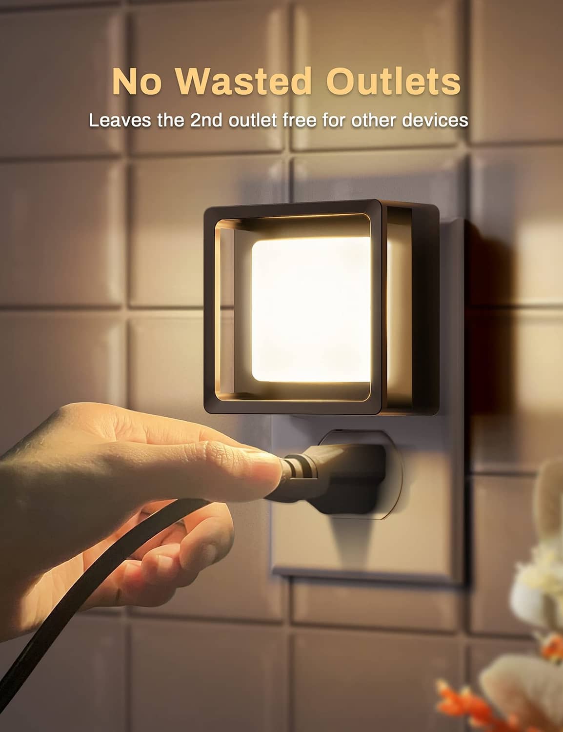Plug-in wall LED night light with square glowing panel as hand inserts plug