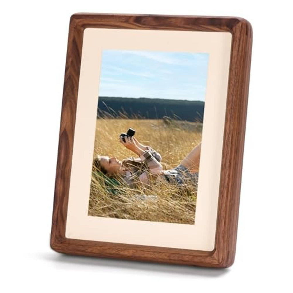 Walnut wood picture frame with white mat, holding a landscape photo