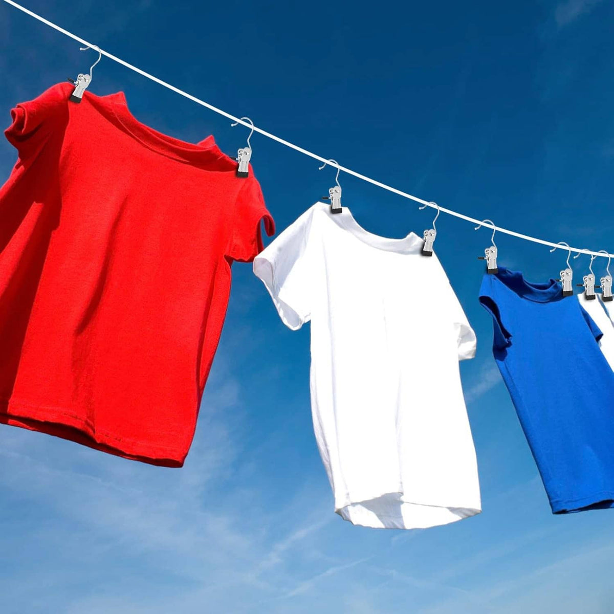 Clothespin-style boot hanger clips holding folded shirts on a clothes rack