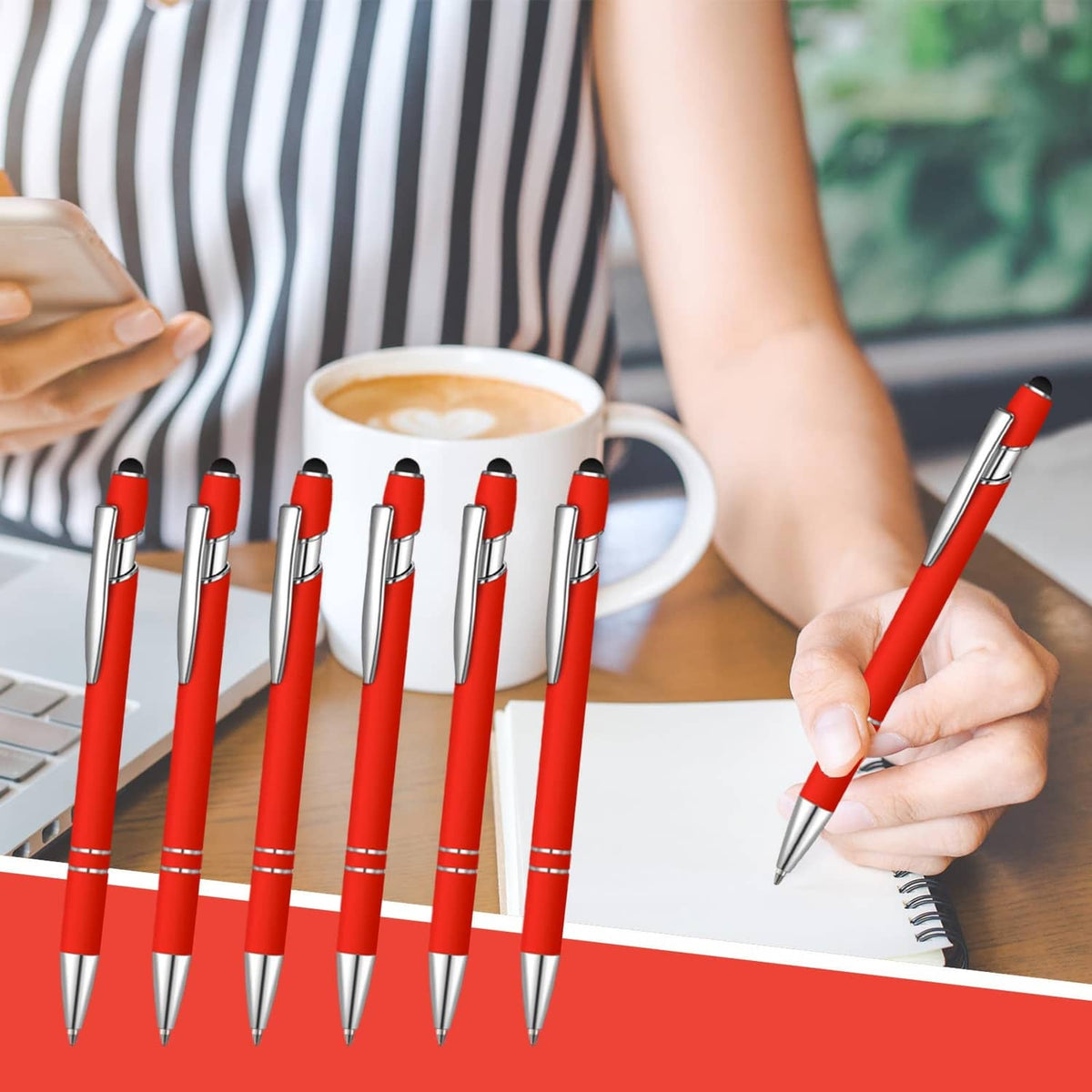 Row of red ballpoint pens with silver barrels, one being used to write