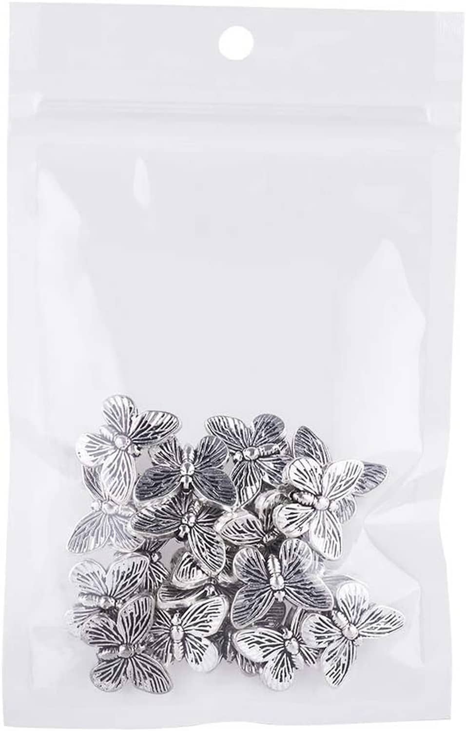 Plastic pouch of antique silver butterfly spacer beads arranged at the bottom