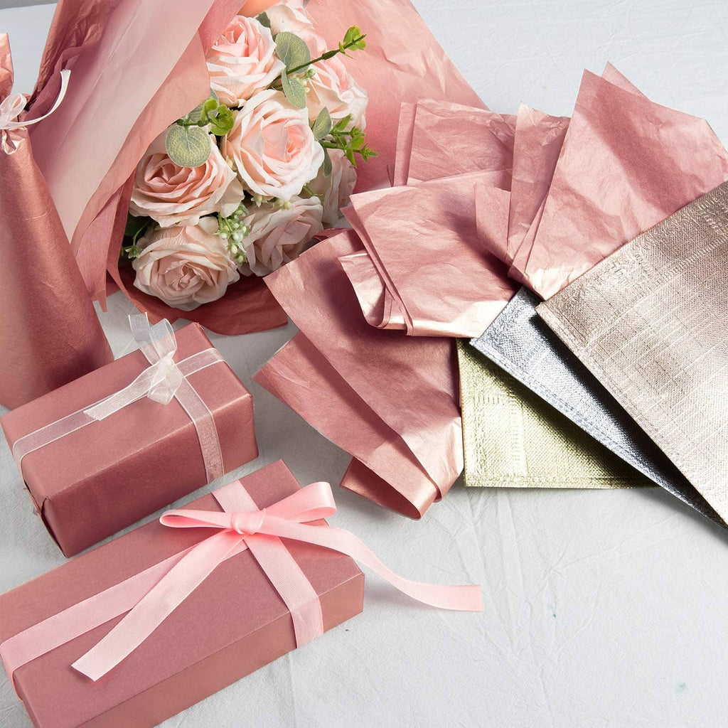 Rose gold metallic tissue paper sheets and wrapped gift boxes with bows