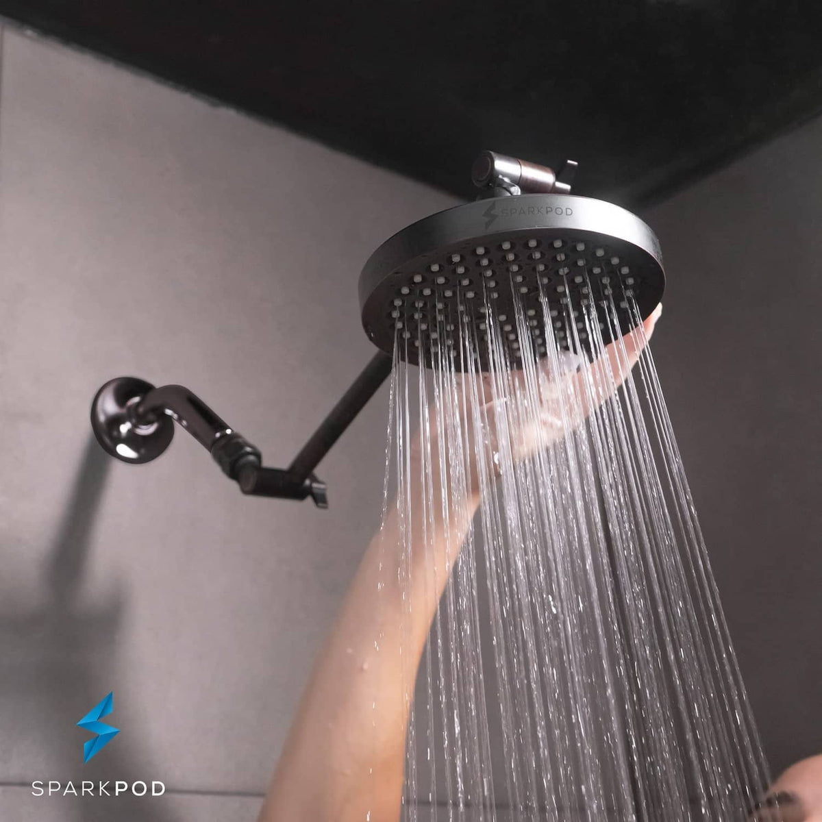 Oil rubbed bronze 6-inch rain shower head releasing steady overhead water flow