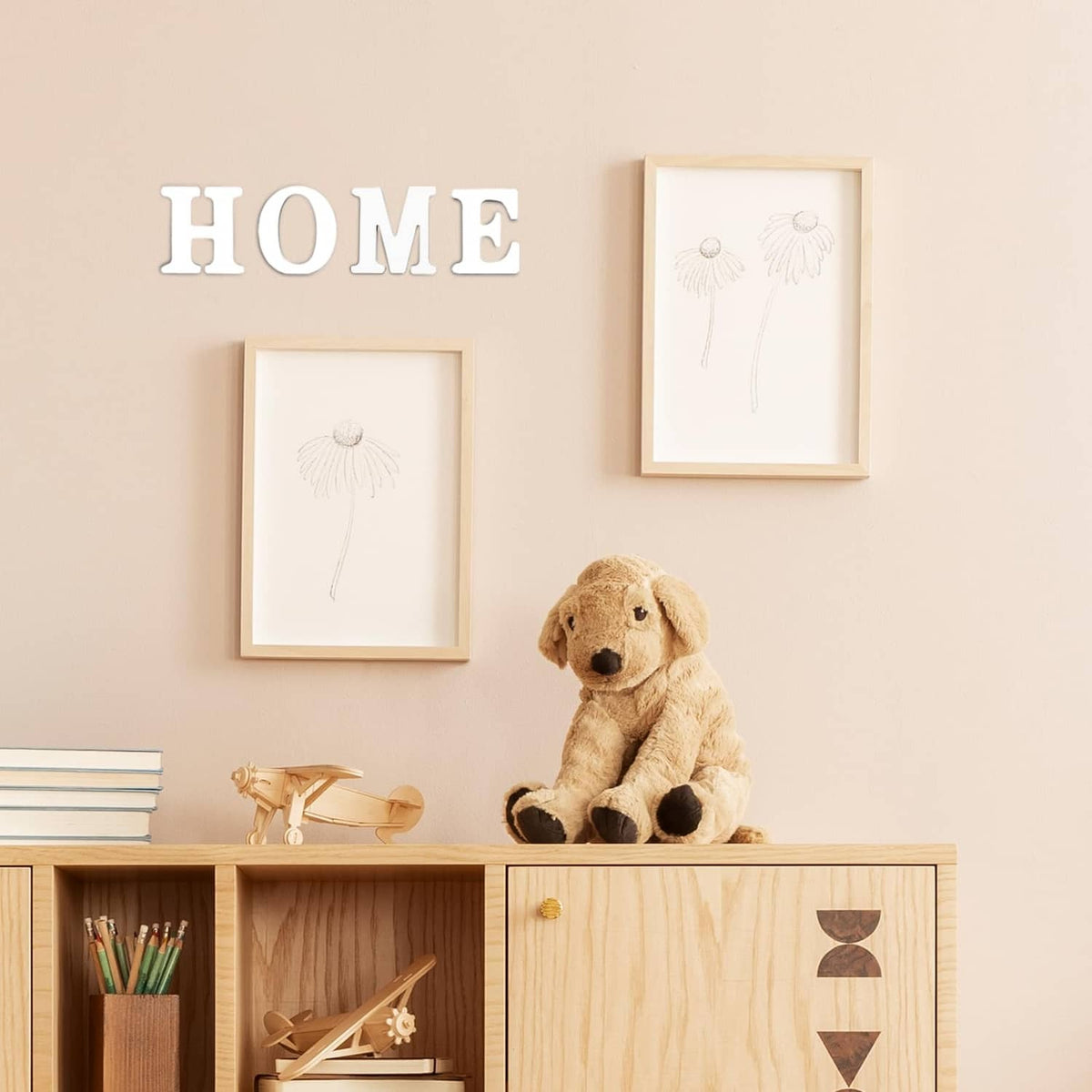 HOME wall decor with framed prints and a dog statue on a wooden cabinet