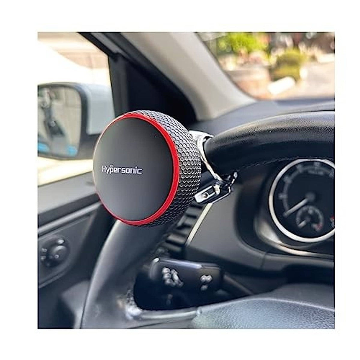 Steering wheel knob spinner attached to vehicle steering wheel, black grip with red rim