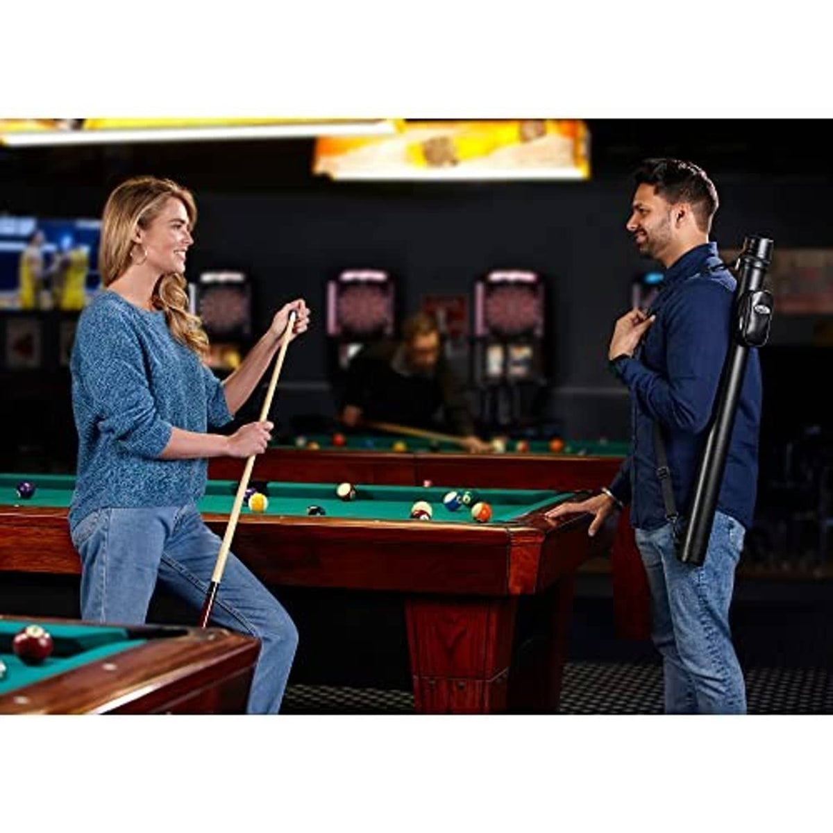 Black pool cue hard case held by a player at a billiard table