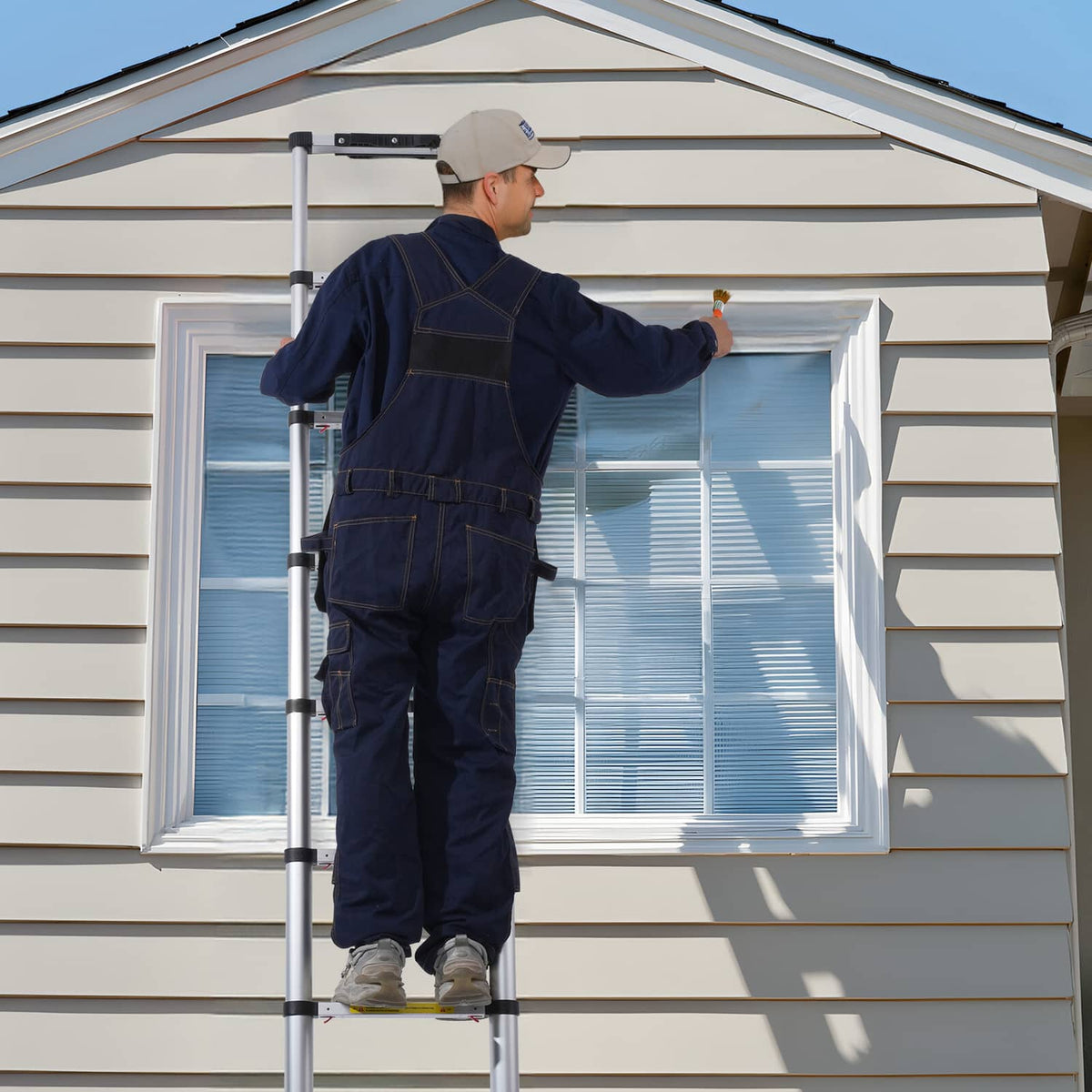 Extended telescoping ladder with silver rails and black rung supports