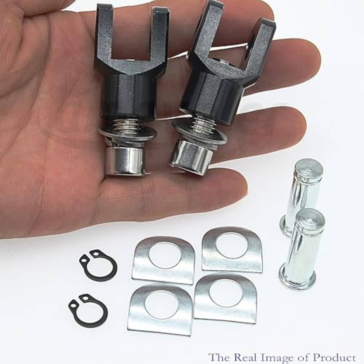 Black clevis mounts, threaded bolts, and washer plates held in hand with spare pins
