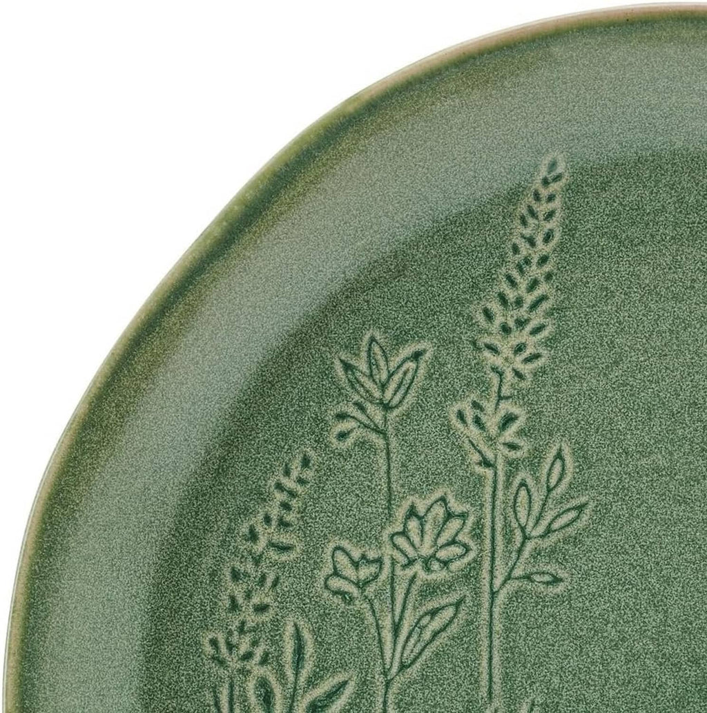 Close-up of green plate with embossed floral-and-leaf botanical design