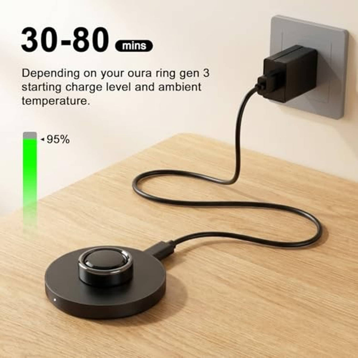 Black charging dock with cable plugged into wall outlet and ring holder on table