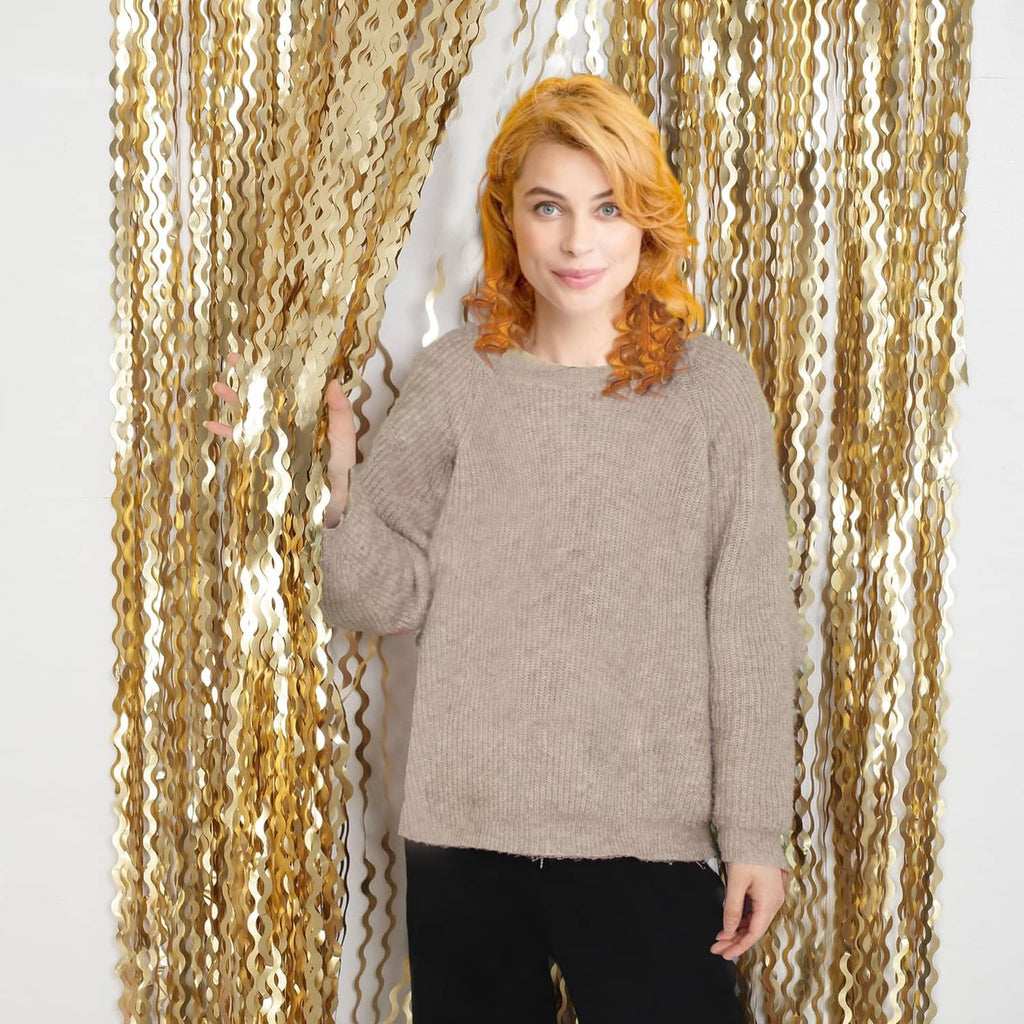 Champagne gold tinsel foil backdrop curtain panel draped behind person