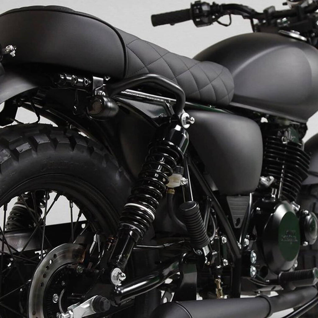 Close-up of black rear shock absorbers with coil springs on a motorcycle