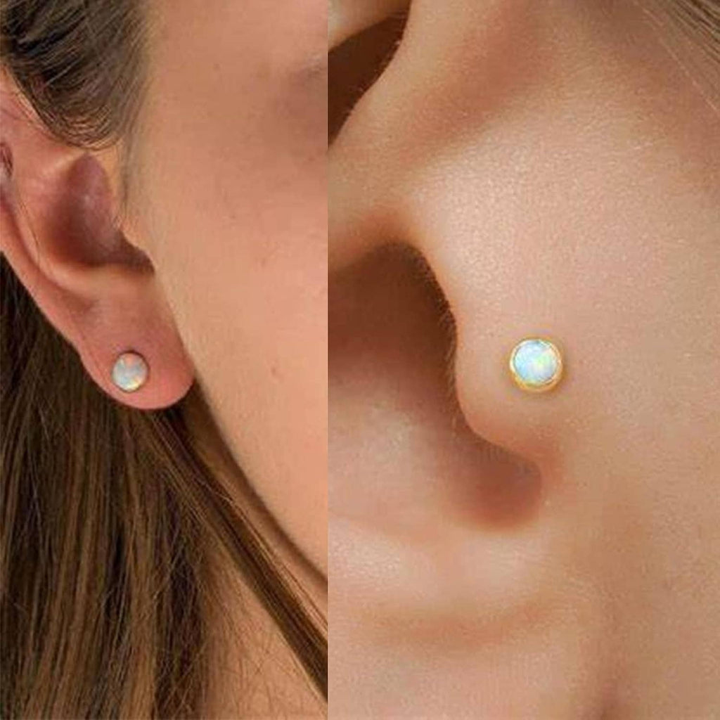 Gold opal stud earrings shown on ear in close-up detail