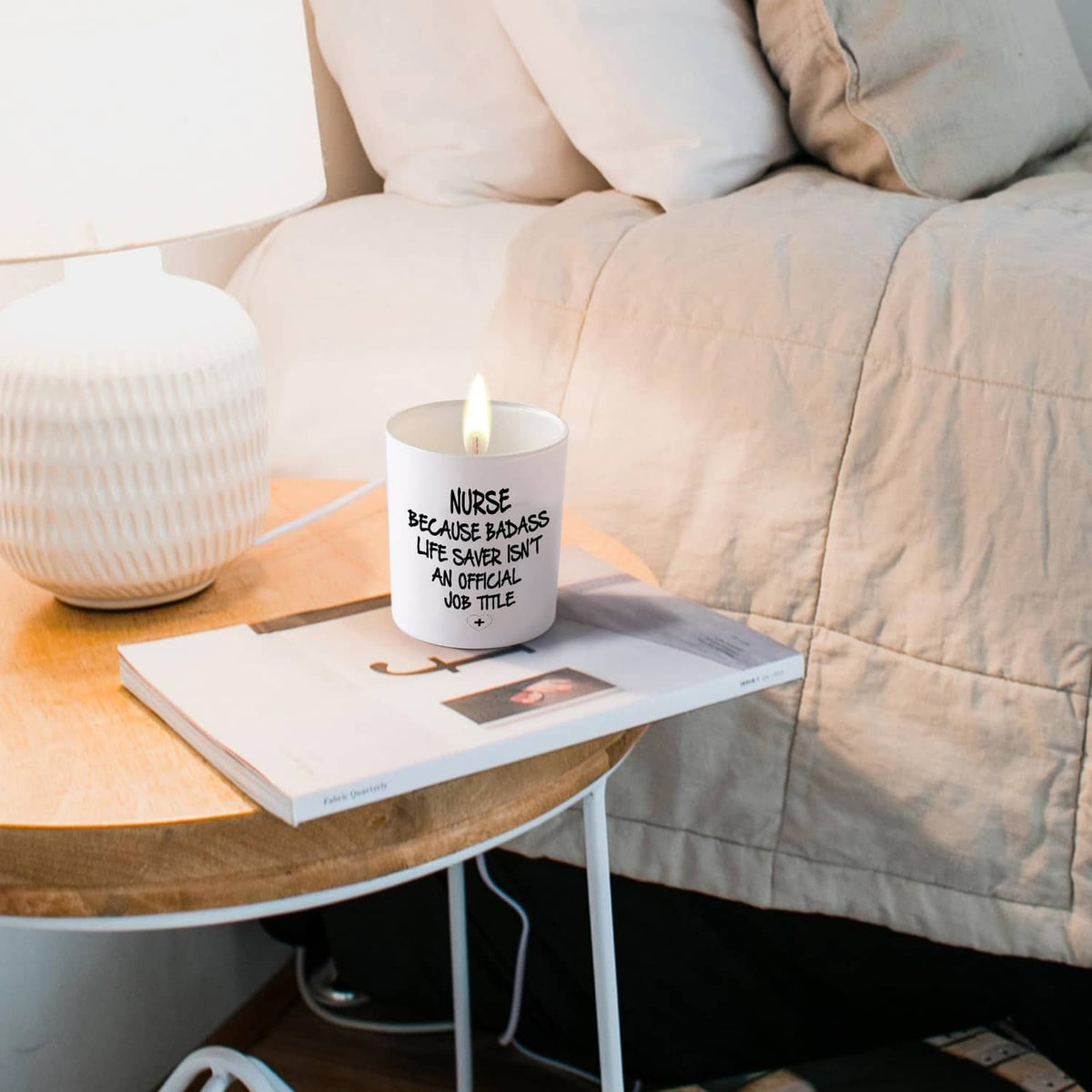 White lit candle jar, 'NURSE BECAUSE BADASS...' quote and plus icon