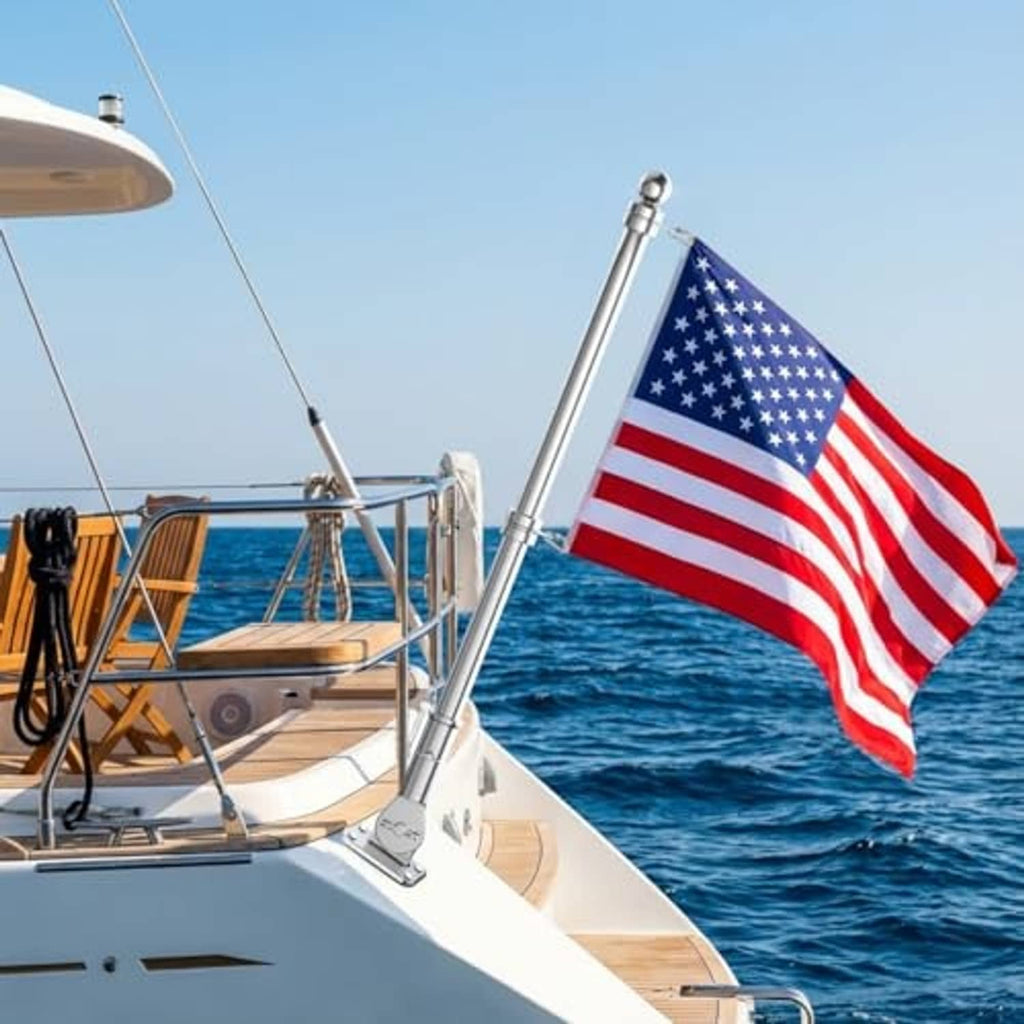 Boat-mounted stainless flagpole with ball finial, waving American flag