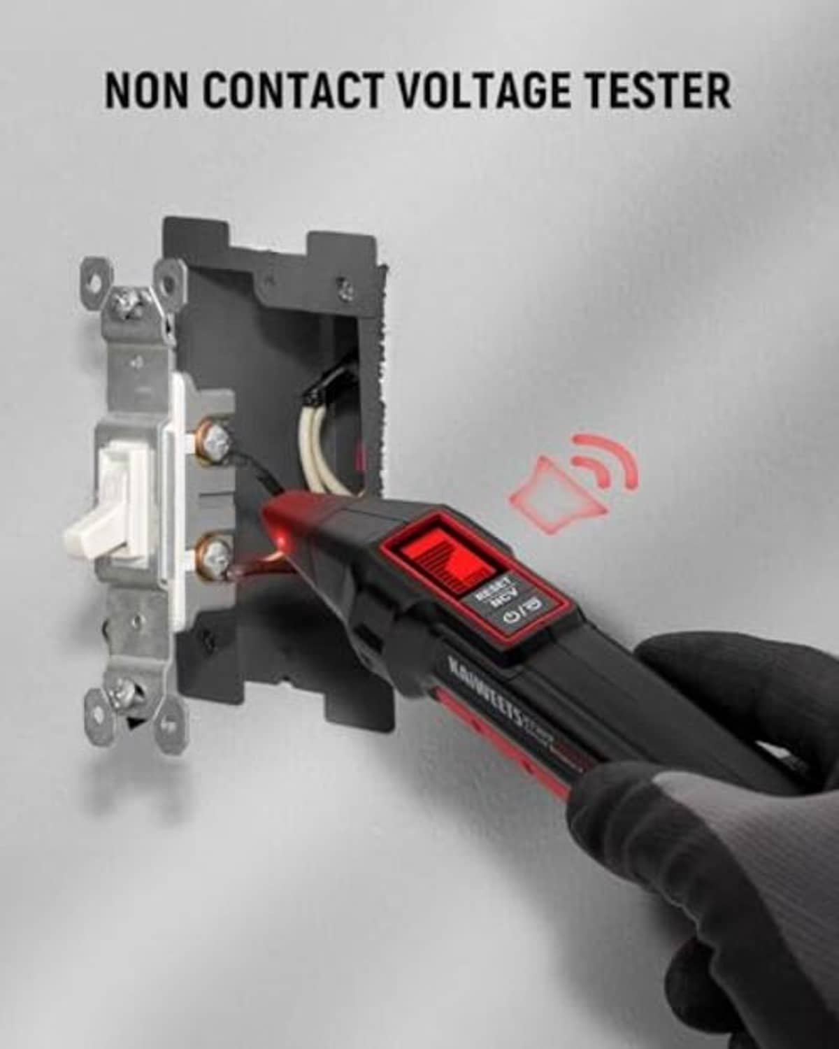 Non-contact voltage tester probe with red LCD reading, held near wall outlet