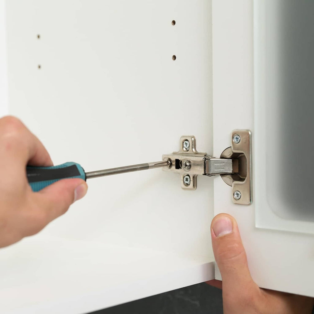 Pan head machine screws fastening a hinge plate to cabinet hardware