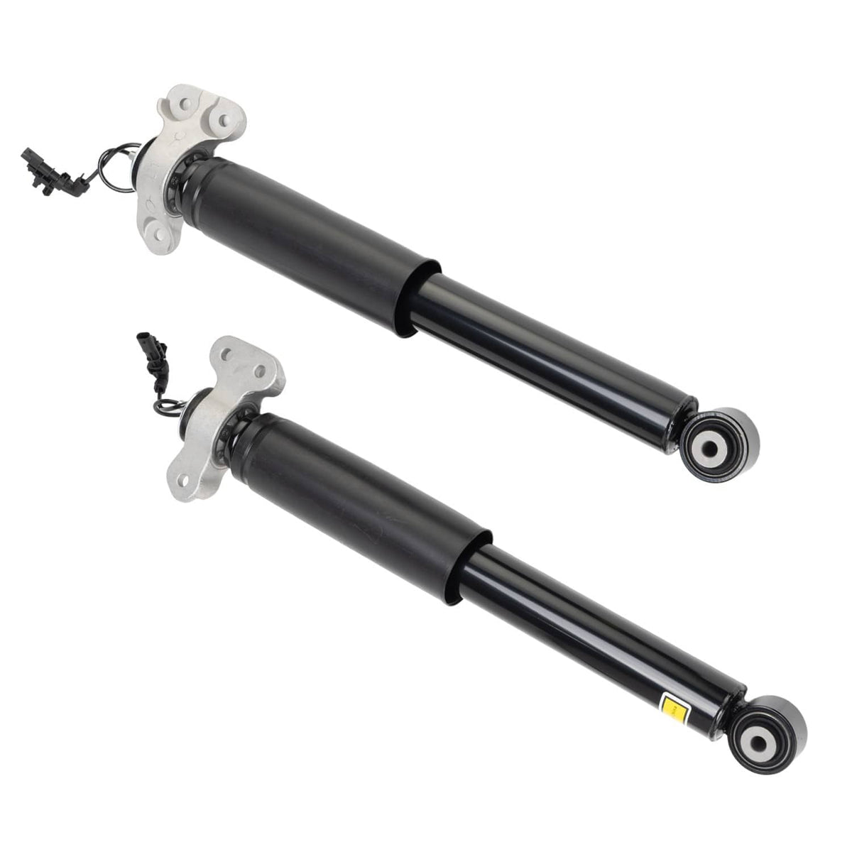 Two rear shock absorbers laid diagonally, black cylinders with silver end mounting brackets