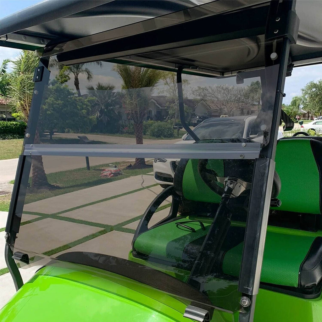 Fold-down tinted windshield installed on a golf cart, clear panel with black frame