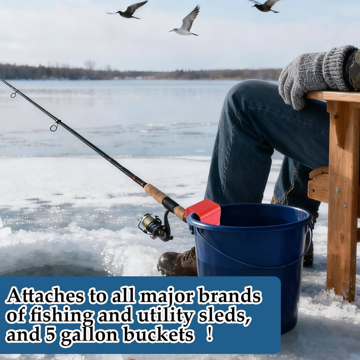 Red plastic rod holder mounted on an ice fishing sled beside a blue bucket