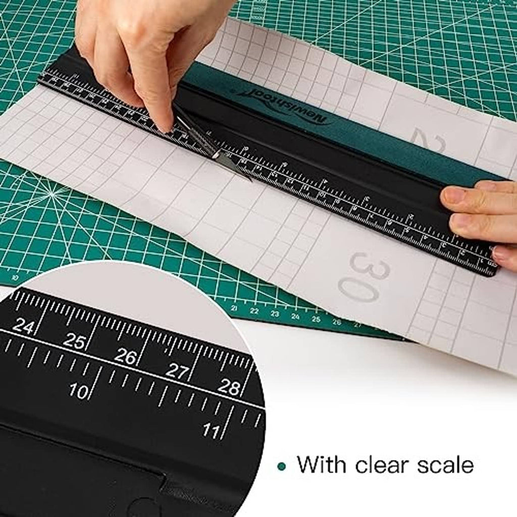 Black ruler squeegee gliding over paper grid material with teal felt pad.