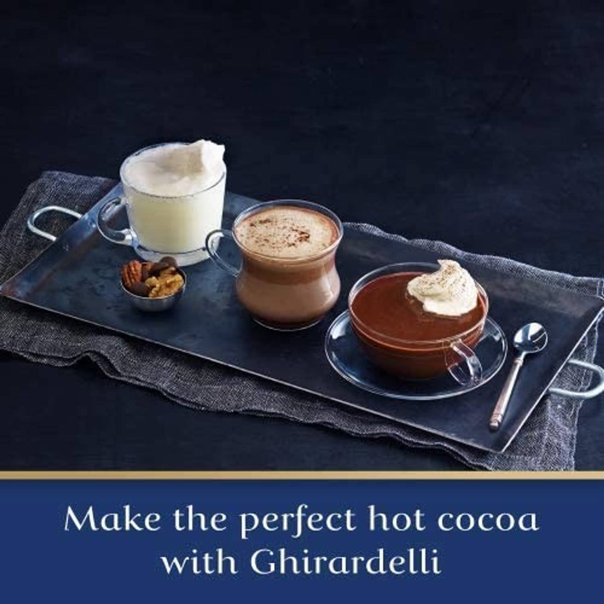 Hot cocoa set on a tray with mugs, marshmallows, and a small cocoa pouch