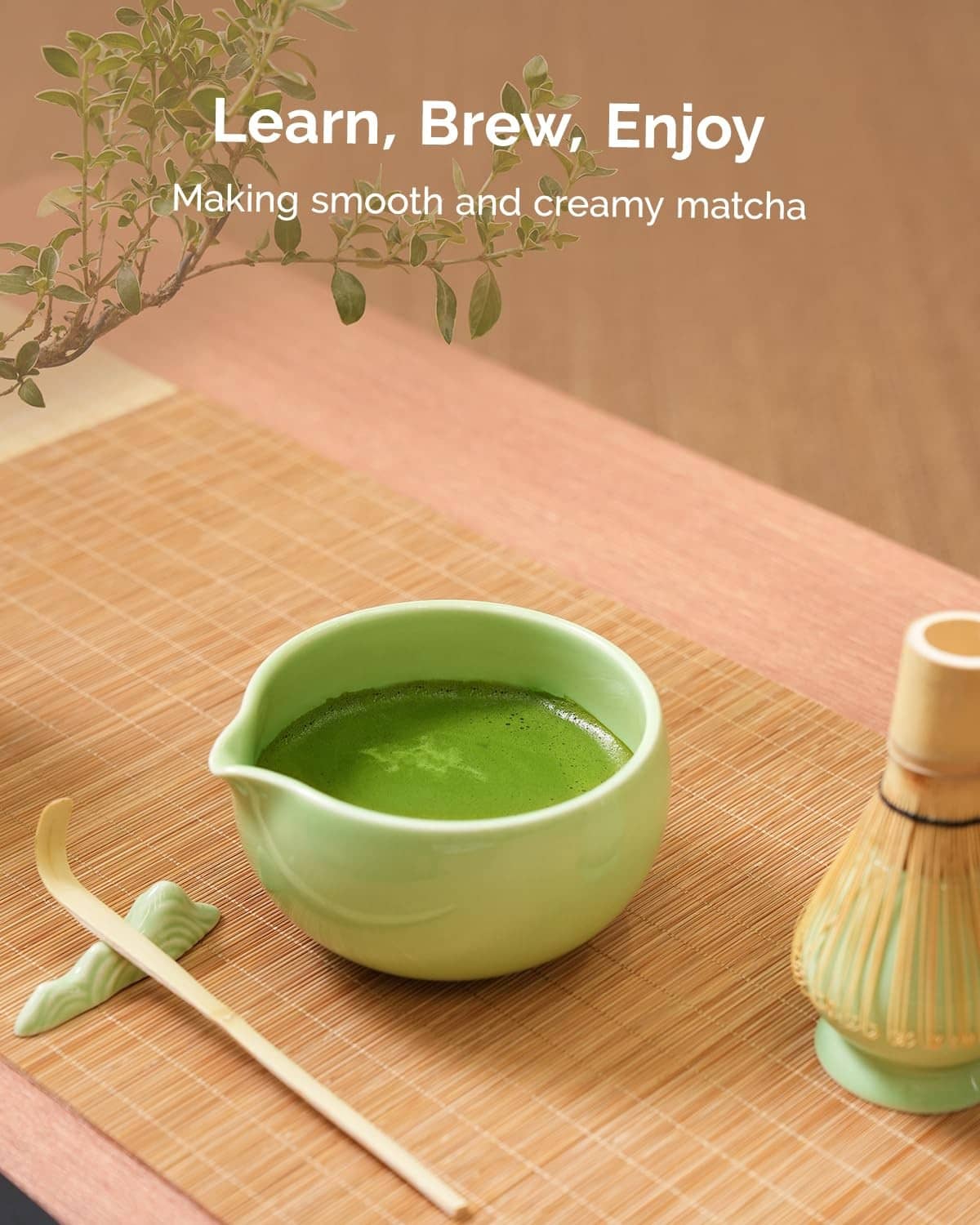 Green matcha bowl with whisk and matcha on a bamboo mat