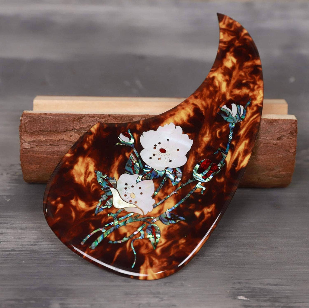 Acoustic guitar pick guard, tortoiseshell design with white flower abalone inlay and teal accents