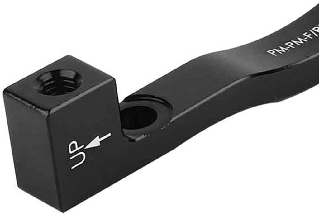 Close-up of black adapter bar with threaded hole and mounting direction arrow