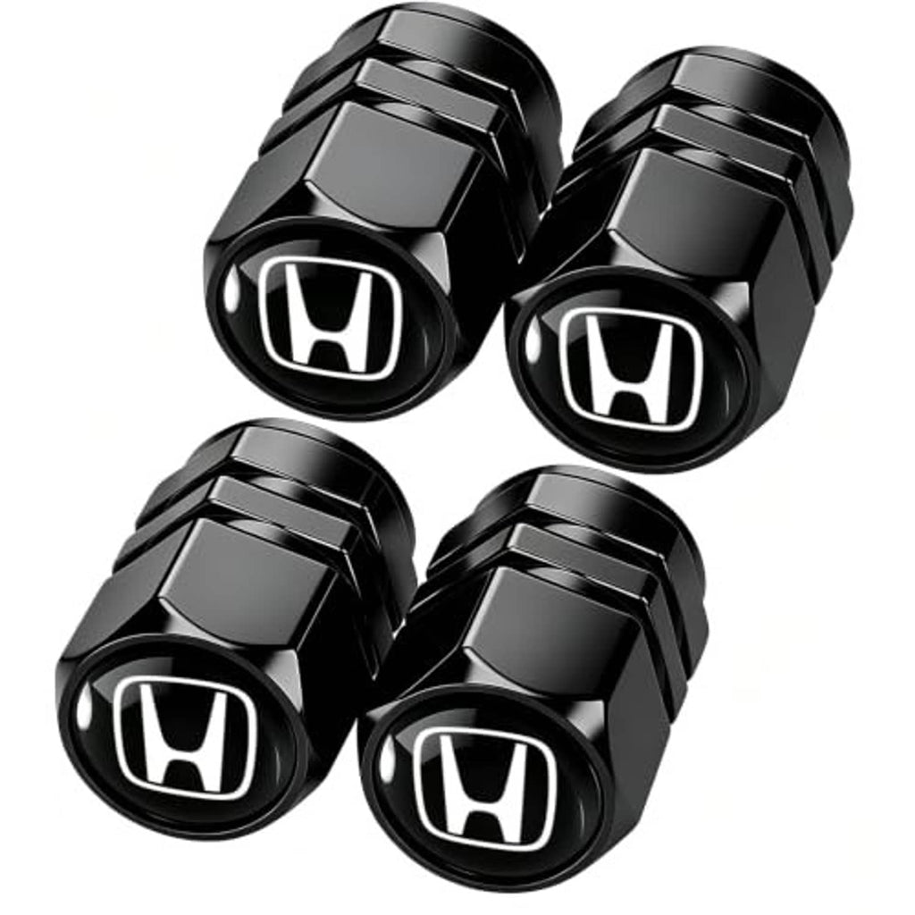 Four black metal tire valve stem caps with Honda logo, faceted hex shape