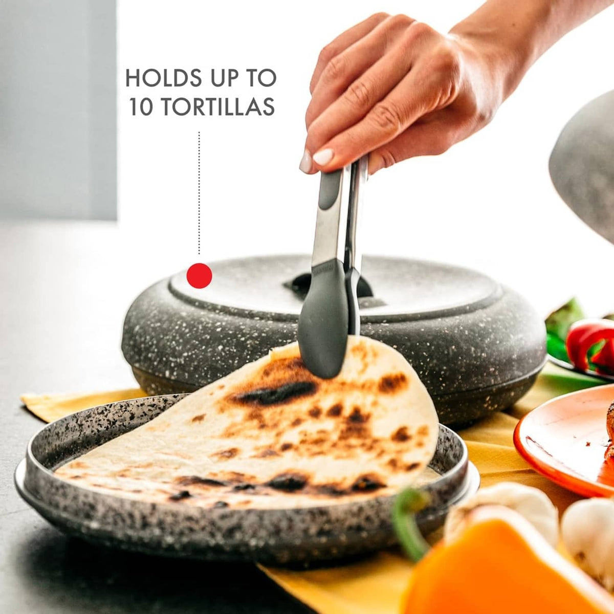 Granite-pattern tortilla warmer holding tortillas on the open base, black handle lid