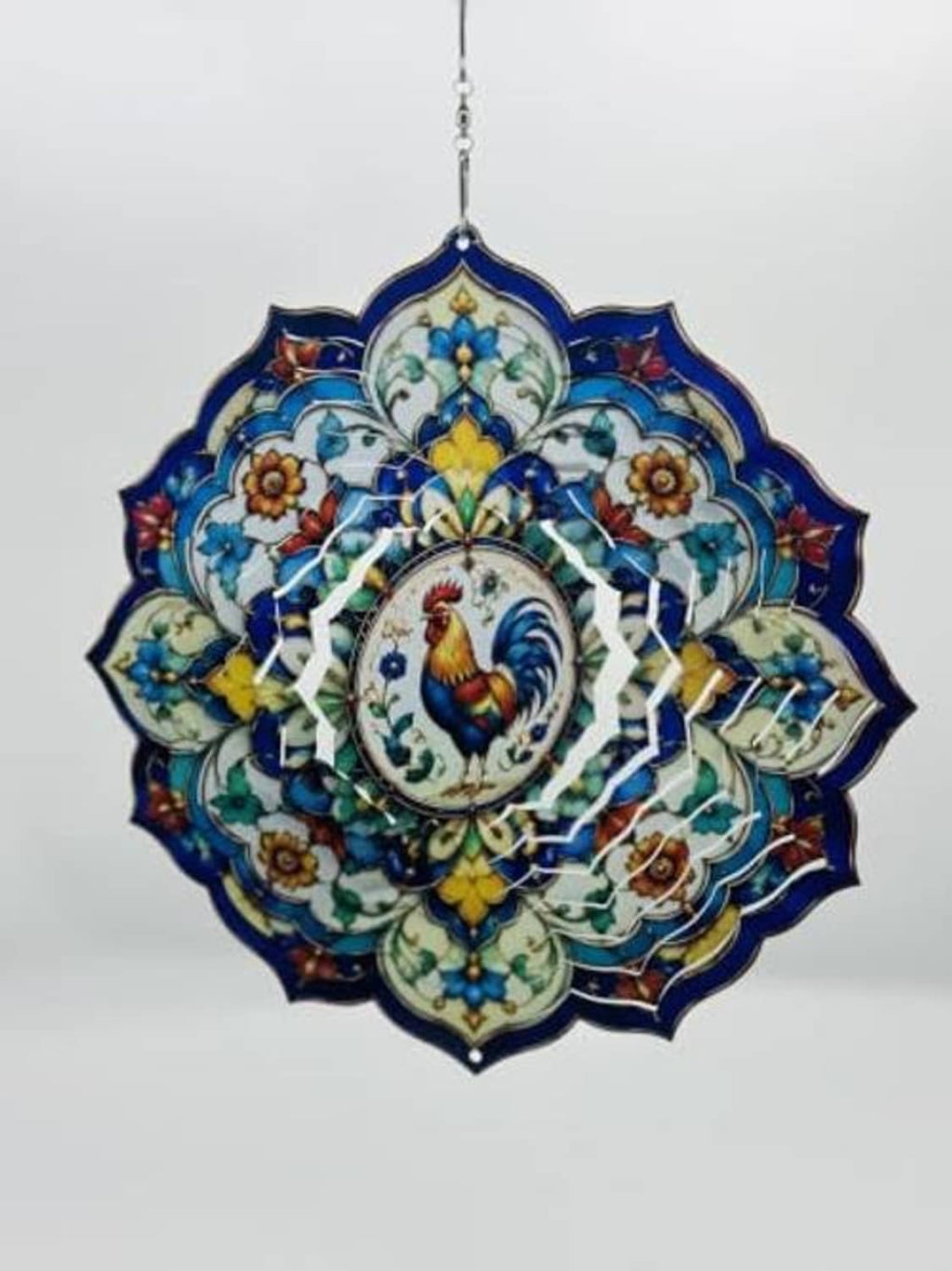 Rooster wind spinner mandala with centered rooster medallion, blue border, and chain