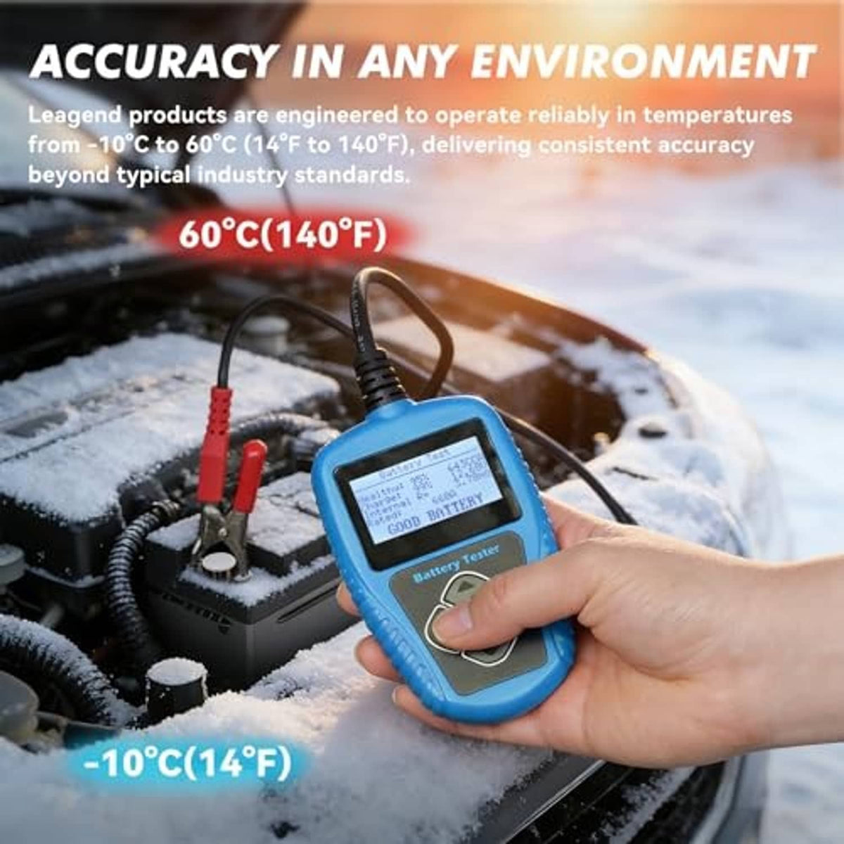 Blue handheld battery tester held by a hand with clamp leads attached